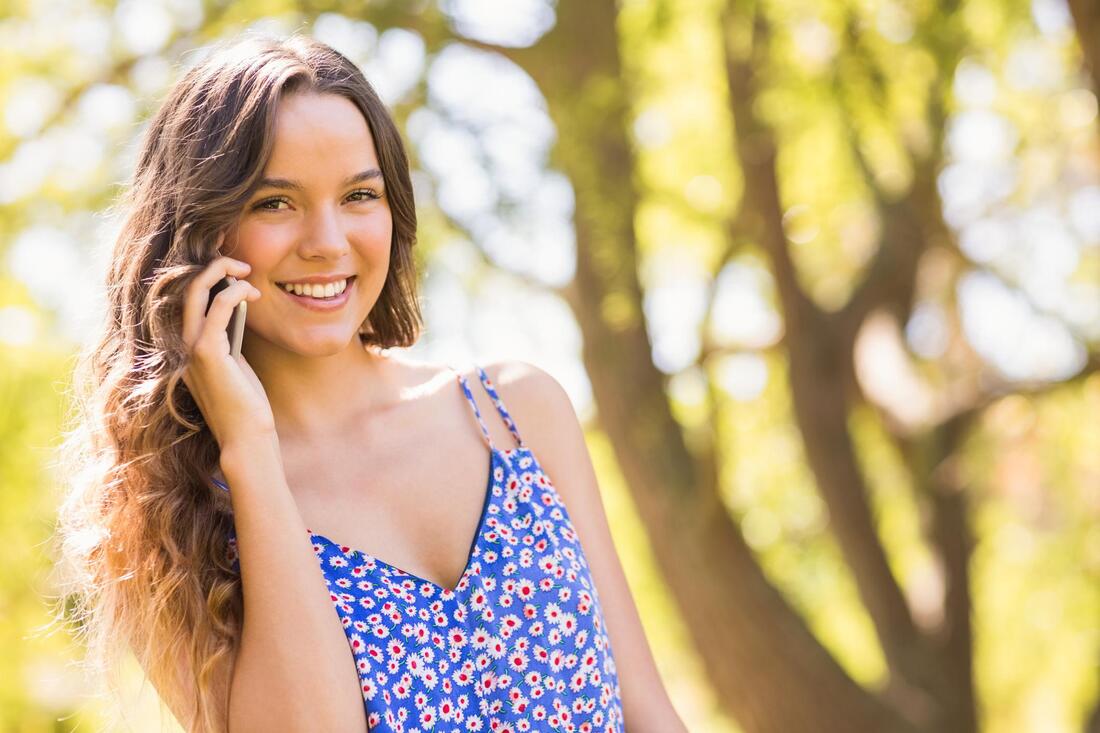 woman smiling taking phone call